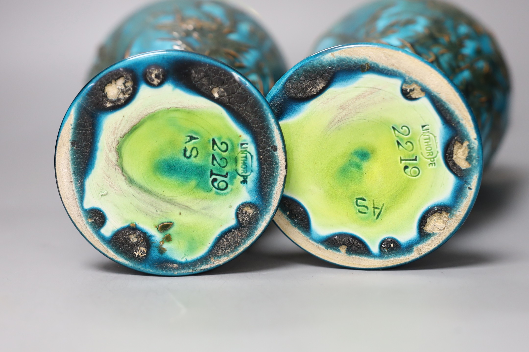 A pair of Linthorpe turquoise glazed pottery vases, impressed model no 2219, incised mark AS. 36cm high
